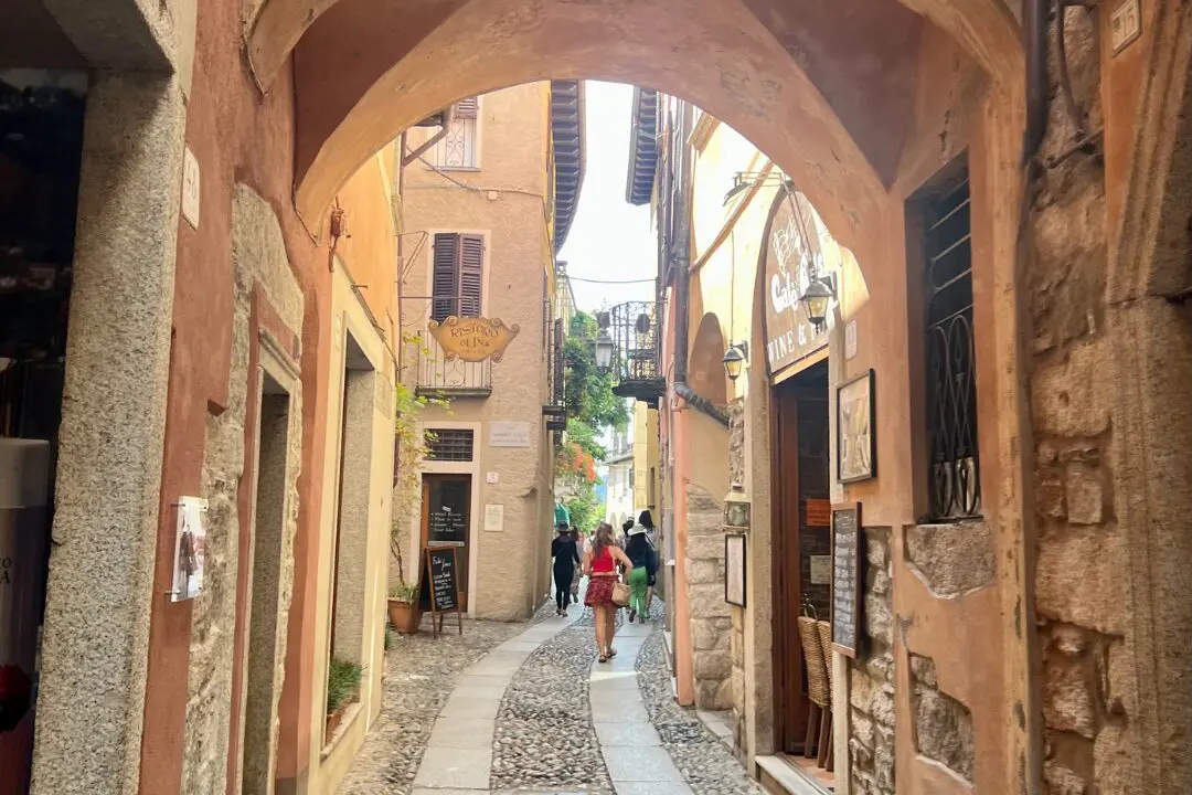 Charming cobblestone alley with colorful buildings in Orta San Giulio, Italy